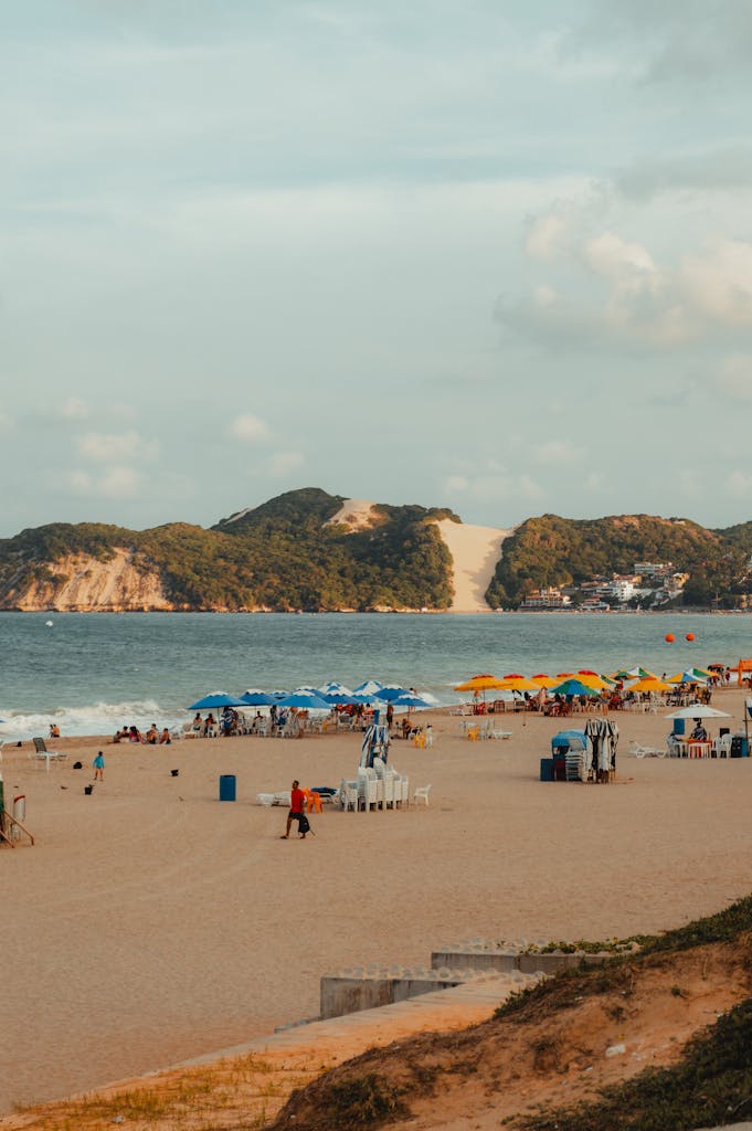 Vibrant beach scene at Ponta Negra, featuring Morro do Careca in Natal, Brazil.